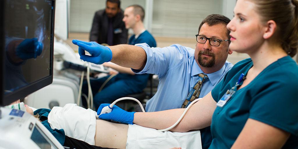 Sonography Program faculty member instructing a student during an ultrasound