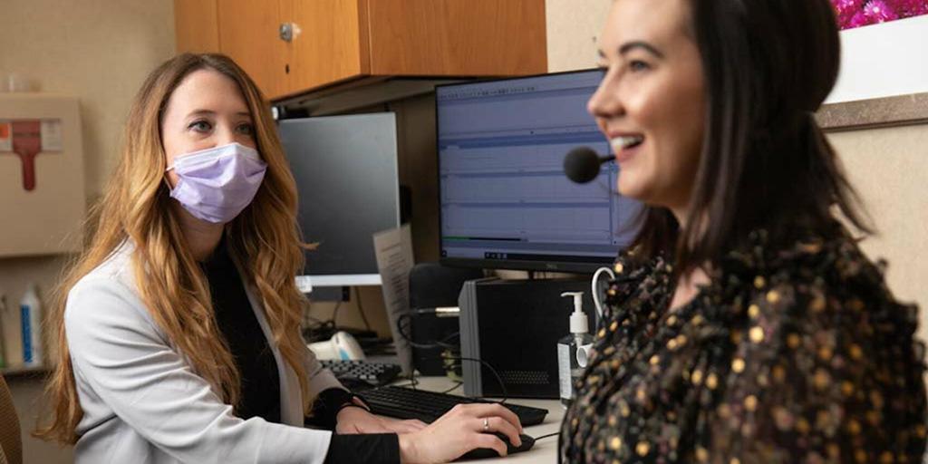 Speech language pathologist assists a patient in a speech test in the exam room