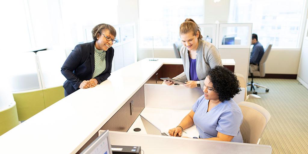 Mayo Clinic administrative employees talking and collaborating in an office space