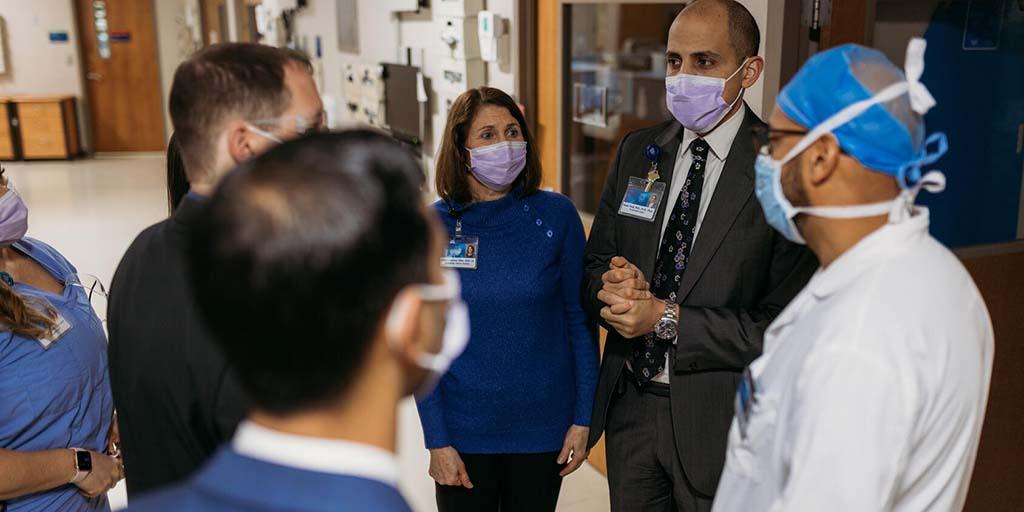 Abdominal transplant surgery fellows and faculty in the hallways of the hospital
