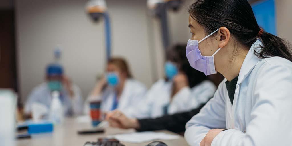 Abdominal transplant surgery fellows and faculty in a meeting room