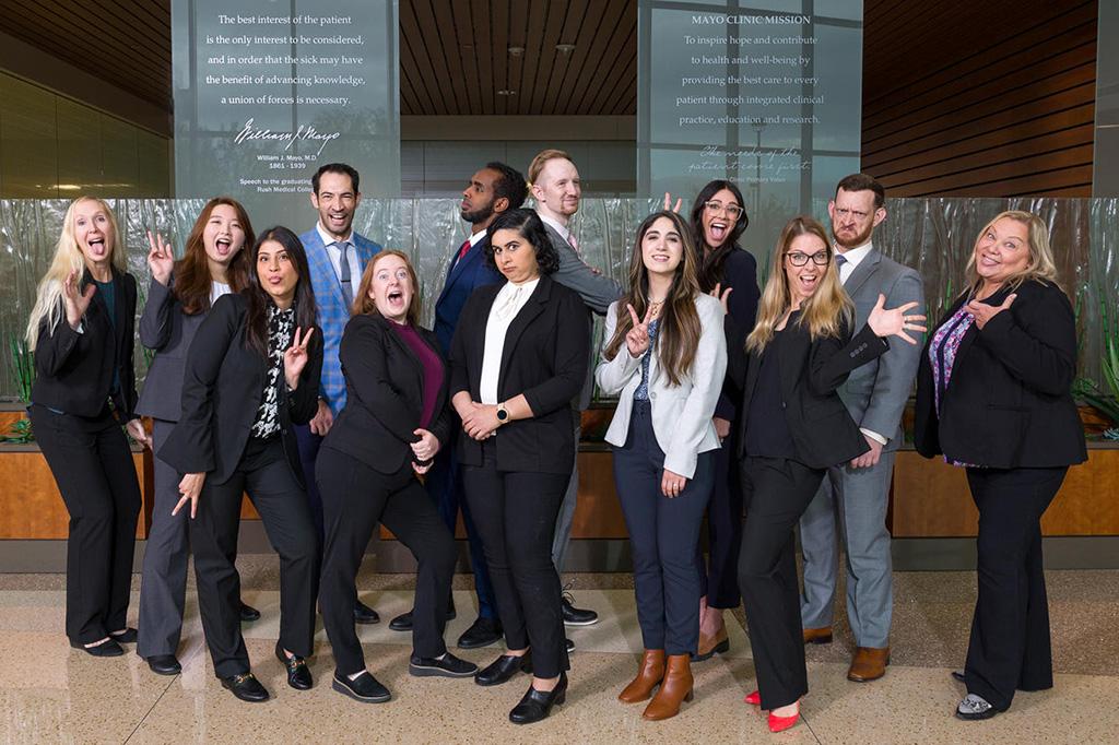 Twelve people from the Adult Neurology Residency in Phoenix, Arizona, posed for a group photo having fun and acting silly.