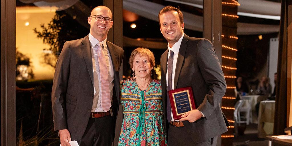 Brooks Johnson, MD, Anesthesiology resident, is presented with a research award during the Anesthesiology and Pain Medicine residency program graduation