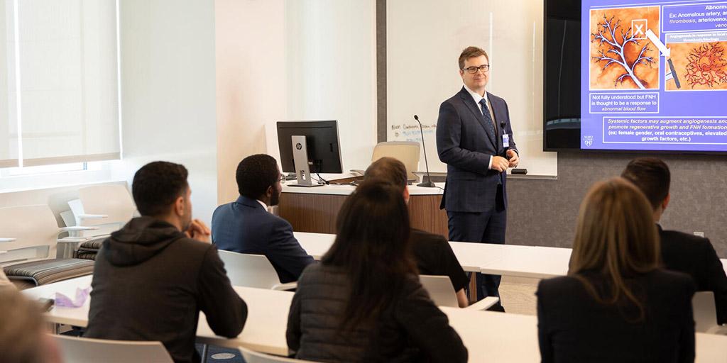 Body Imaging fellows and faculty talking in a classroom at Mayo Clinic in Jacksonville, Florida.