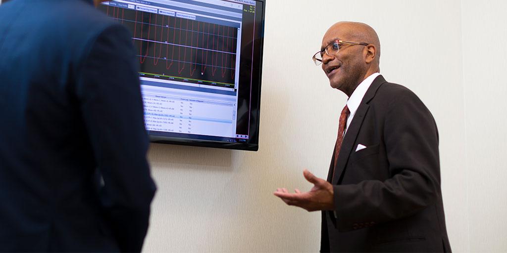 Man showing and explaining something on computer screen