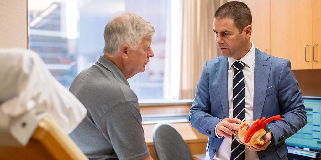 A Mayo Clinic electrophysiologist meeting with a patient