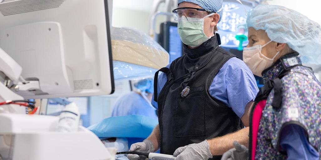 Two people from the Cardiology, Echocardiography Fellowship (Florida) at Mayo Clinic in Jacksonville, Florida, looked at a monitor while performing a procedure.
