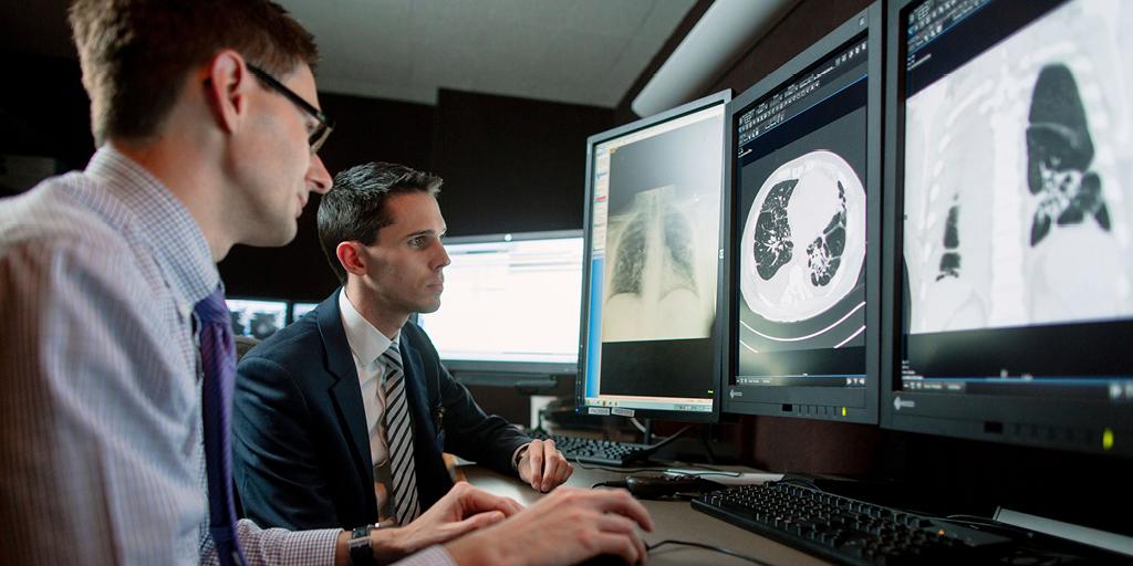 Mayo Clinic cardiothoracic radiologist reviews an imaging scan on a computer monitor with a fellow at Mayo Clinic in Rochester, Minnesota.