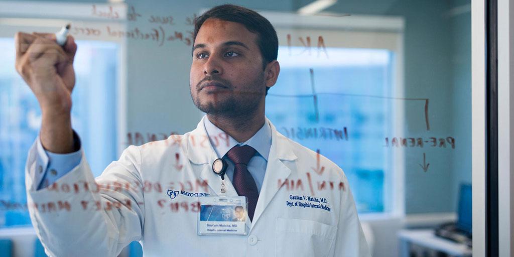 Mayo Clinic researcher writing equations in the lab