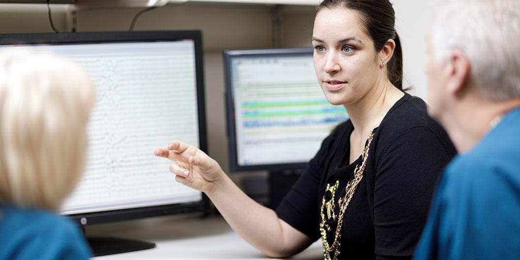 Physician examining an EEG scan with a patient