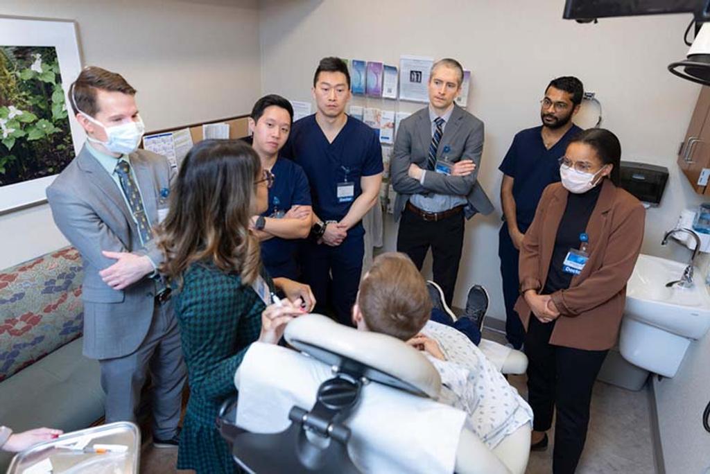 Hafsa Cantwell, MD, Dermatology consultant, speaks while leading residents in a cosmetic injection practice session.