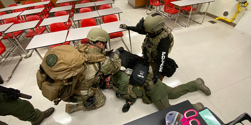 EMS personnel practice an emergency simulation in the classroom
