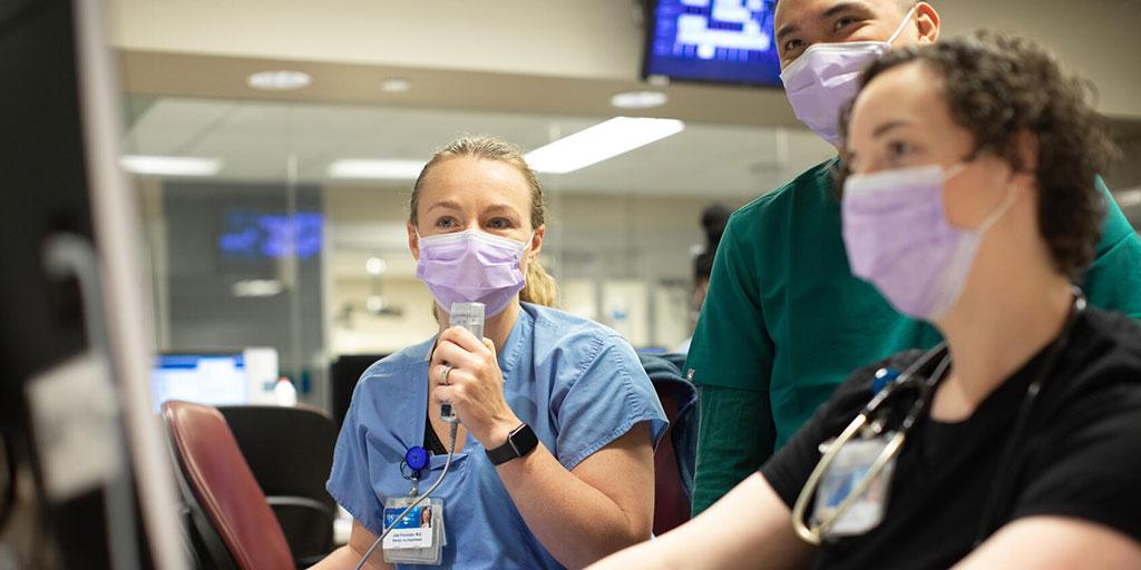 Emergency medicine residents talking and collaborating