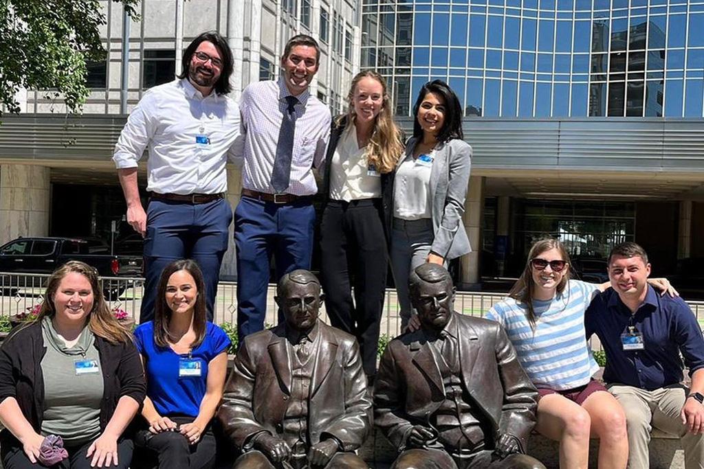 Residents gathered for a group photo with bronze statues of the Mayo brothers.