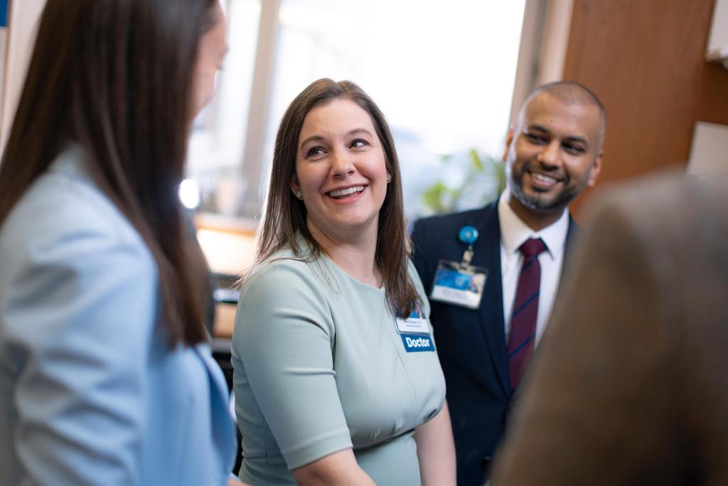 General Internal Medicine (GIM) staff discuss patient care together in an office