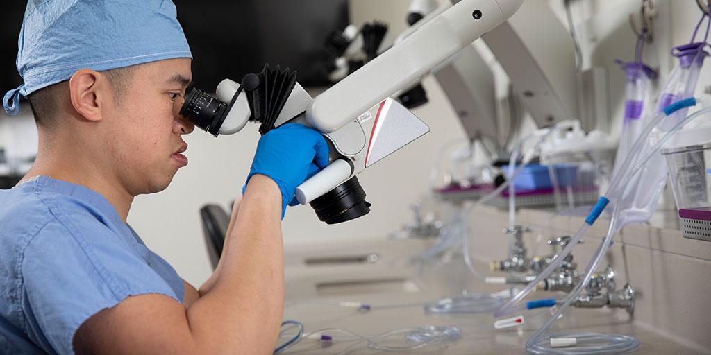 Surgeon looking into a microscope