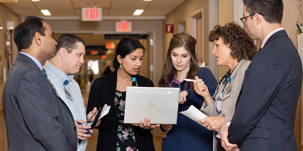 Geriatric medicine fellows speaking with faculty in the hall at Mayo Clinic in Rochester, Minnesota.