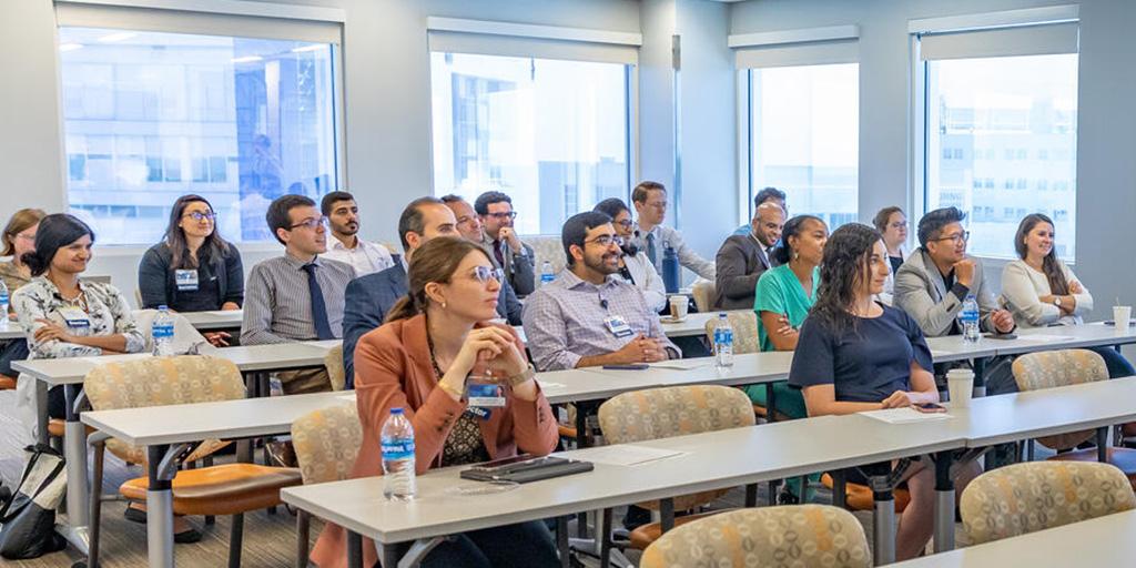 Twenty people sitting in a classroom listening to a speaker from the Hematology/Oncology Fellowship program in Jacksonville, Florida.