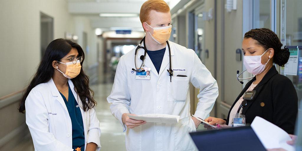 Internal medicine residents at Mayo Clinic in Florida talk in the hospital hallway