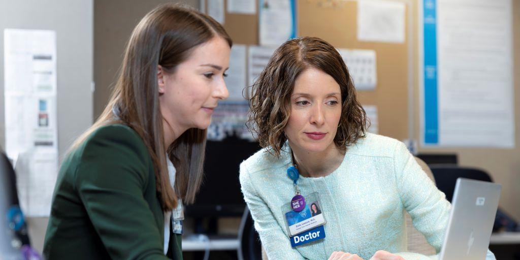 Dr. Leasure, Associate Program Director for Resident Continuity Clinics, collaborates with Dr. Tomasi in clinic.