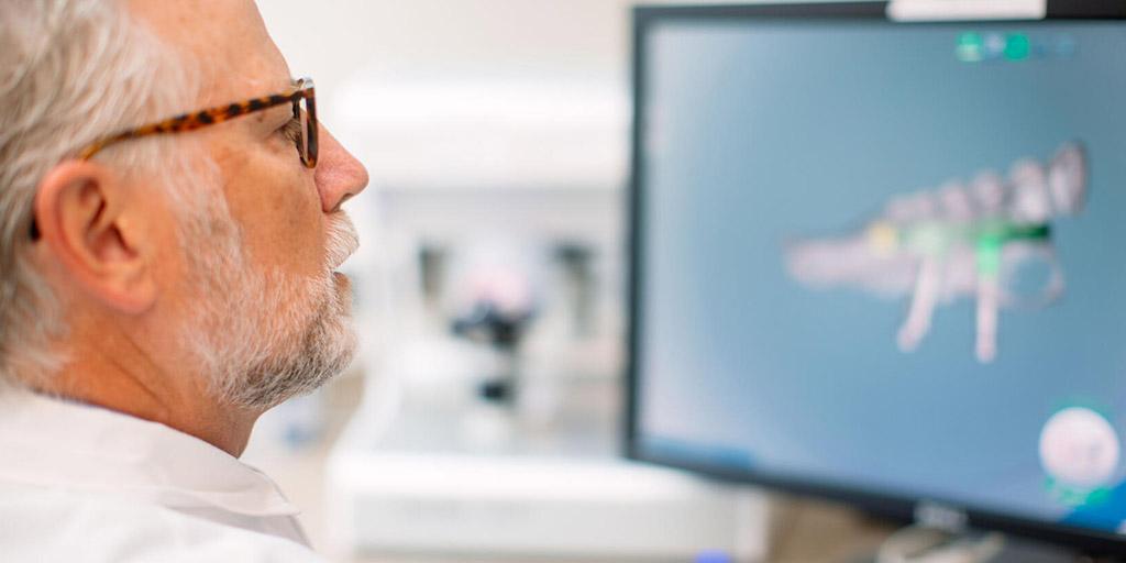 Maxillofacial Prosthetic and Dental Oncology faculty member working on a computer at Mayo Clinic in Rochester, Minnesota.