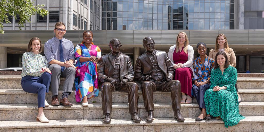 Fellows, faculty, and staff in the Neonatal-Perinatal Medicine Fellowship program pose together with the bronze Mayo brothers statue, 