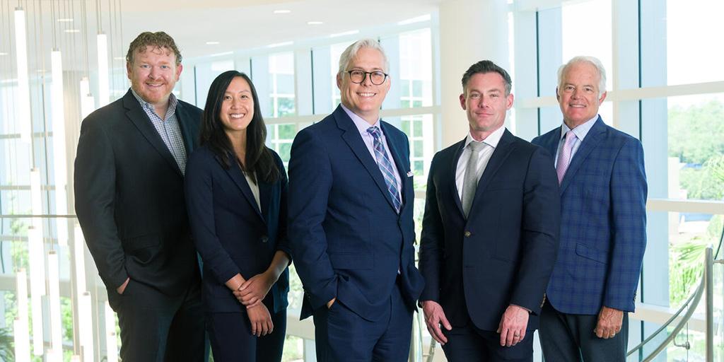 Five people from the Neurocritical Care Fellowship program in Jacksonville, Florida, stand side by side for a group photo.