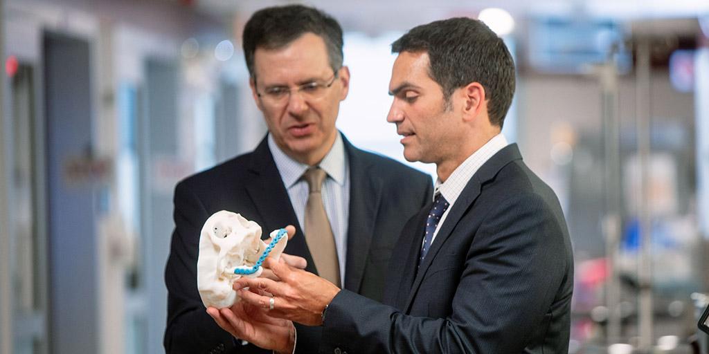 Mayo Clinic oral and maxillofacial surgeons examining a model