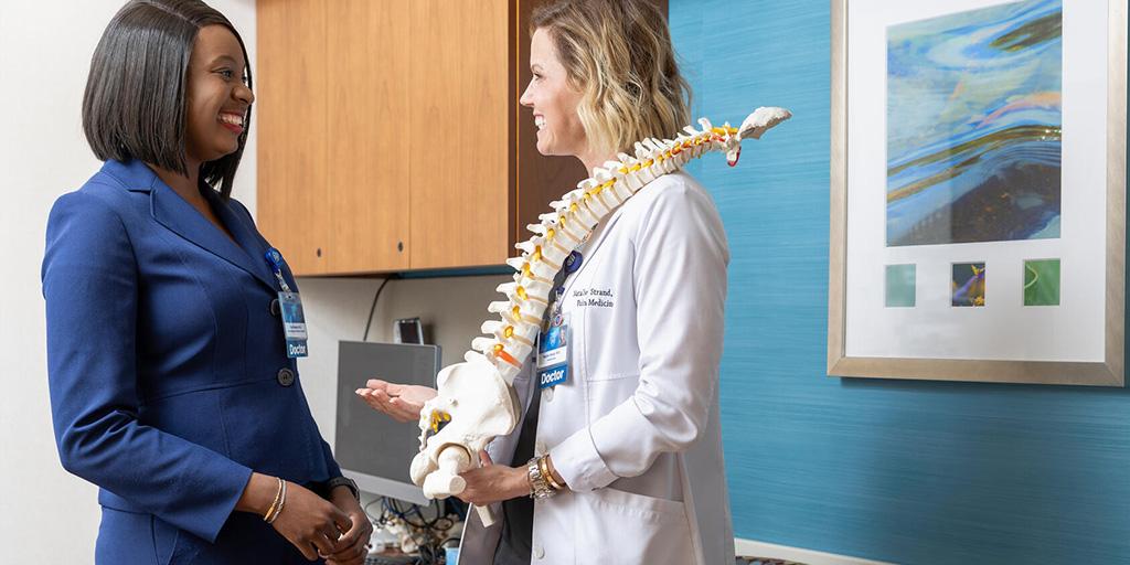 Pain Medicine Staff With Spine Anatomical Model