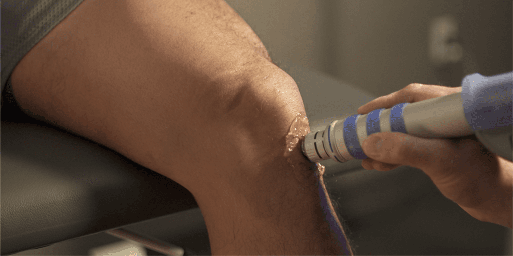 A doctor from PM&R Sports Medicine Fellowship program in Minneapolis, Minnesota, performing an ultrasound on the knee.