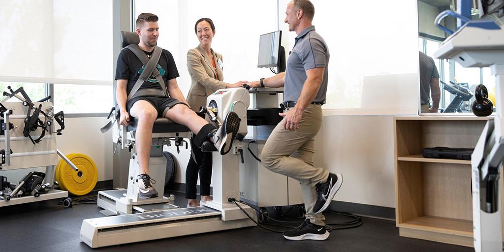 Two Primary Care Sports Medicine Fellowship doctors working with a patient.