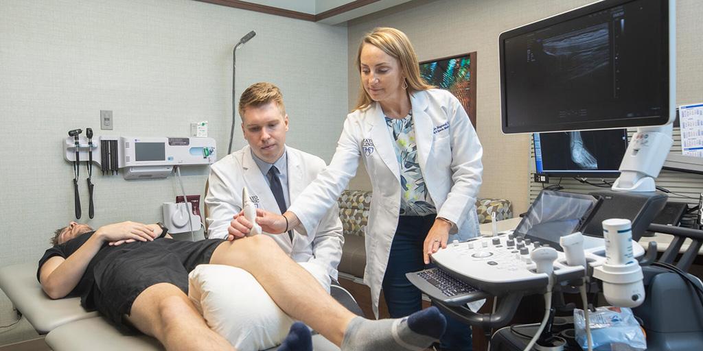 Primary Care Sports Medicine Fellowship program director, Jennifer Maynard, M.D., and doctor working with a patient.