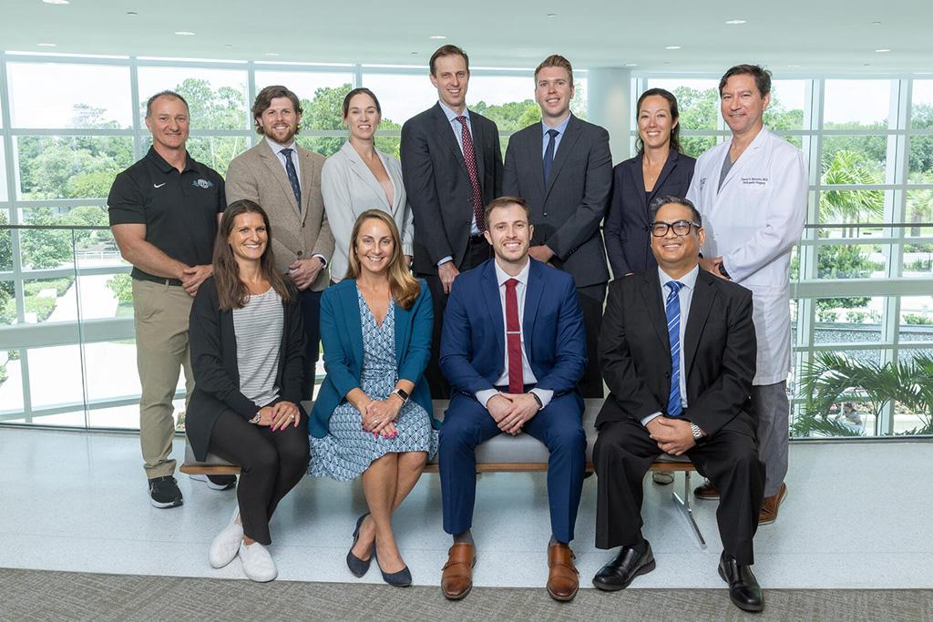 Formal group portrait of eight members of the department and faculty.