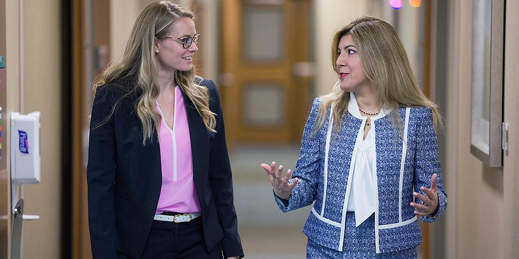 Mayo Clinic pulmonary and critical care medicine faculty member and fellow discussing a patient case while walking in the hospital.