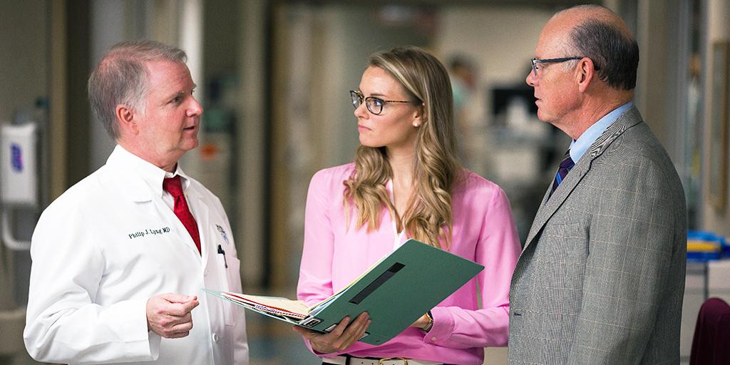 Mayo Clinic pulmonary and critical care medicine faculty members and fellow discussing a patient case in the hospital.