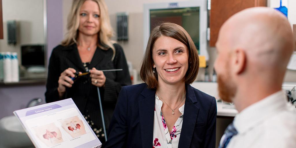 Three fellows from rhinology and skull base surgery fellowship looking at anatomy drawings