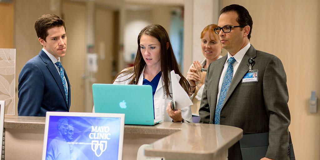 Mayo Clinic faculty and fellows collaborating in the clinic hallway