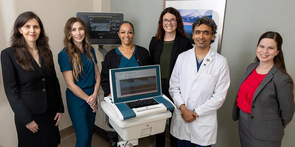 Six people from the Vascular Neurology Fellowship program gathered for a group photo in an exam room.