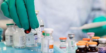 Pharmacy technician in training sorting through medications in a lab