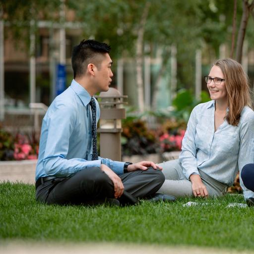 Three medical students talking to each other on the lawn outside of Mayo Clinic Alix School of Medicine in Rochester, Minnesota.