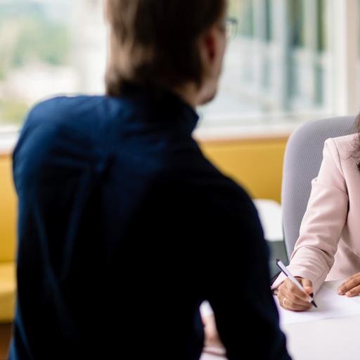 Two Mayo Clinic employees collaborate with each other at Mayo Clinic Alix School of Medicine.