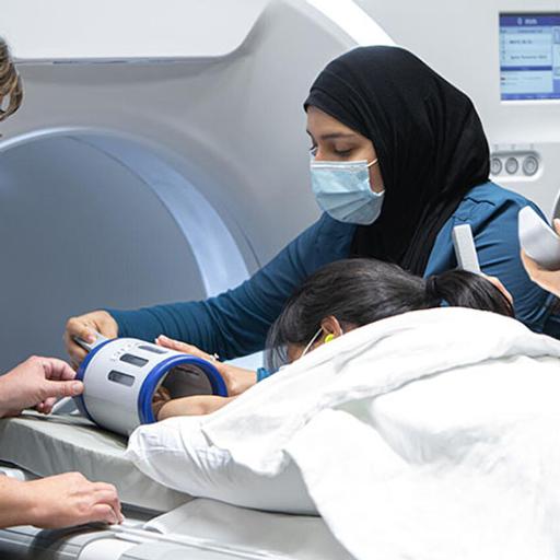 MRI technologist and students prepares a patient for an MRI scan at Mayo Clinic