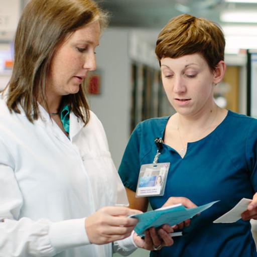Pharmacy professionals reviewing a prescription