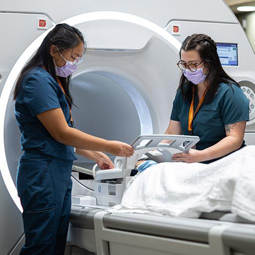 Mia Rossi and Amela Hamzagic practice Magnetic Resonance Imaging (MRI) techniques at Mayo Clinic in Rochester, Minnesota.