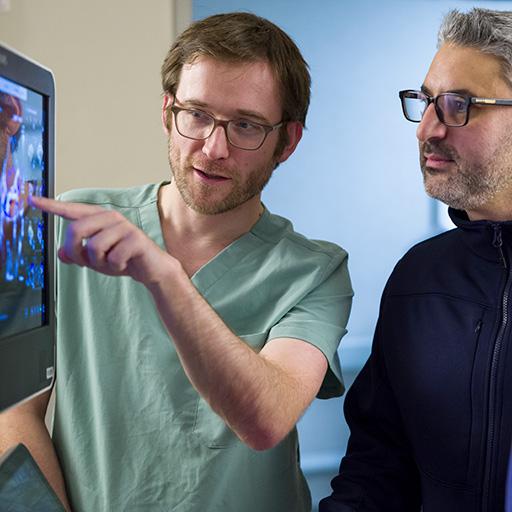 Two people from Cardiology, Echocardiology Fellowship in Arizona looking at screen