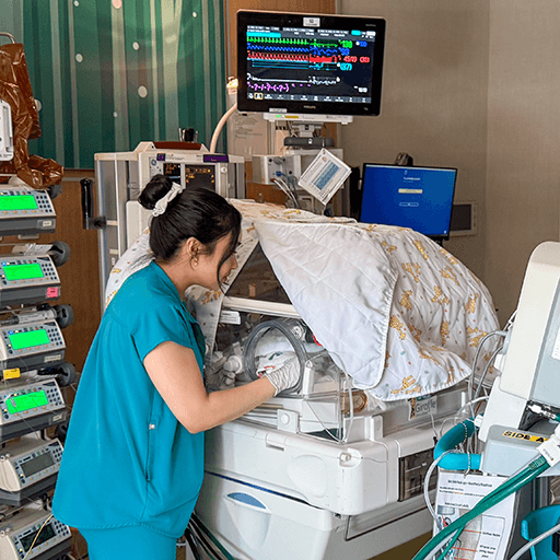 Baby in NICU being monitored by a fellow