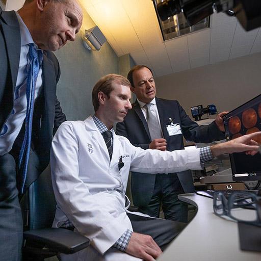 Neuro-ophthalmology fellows and faculty look at scans on a computer at Mayo Clinic in Jacksonville, Florida.