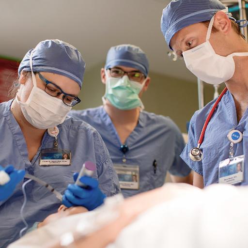 Three neuroanesthesiologists work on a patient.