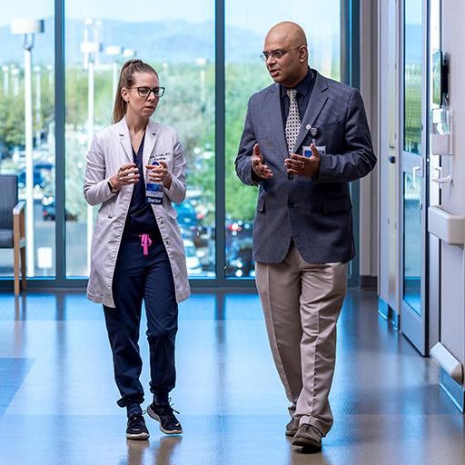 Two fellows from the Neurohospitalist Fellowship in Arizona walking down a hallway