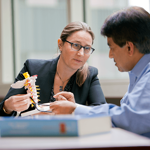 Michelle Clarke, M.D., interacting with a patient using a model.